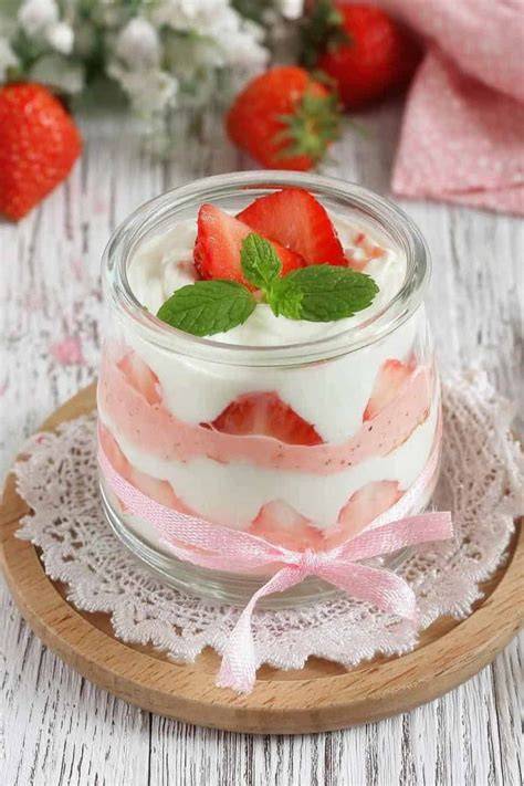 Abwechselnde Schichten aus Quark und Erdbeeren im Glas