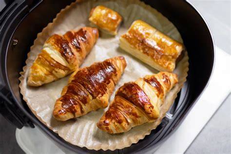 Airfryer mit goldbraunen Croissants im Korb