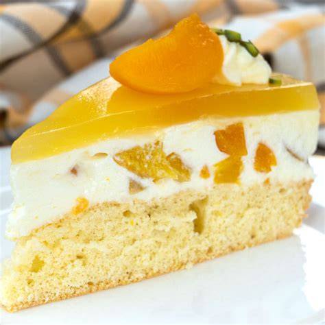 Anschnitt einer Pfirsich-Sahne-Torte mit Biskuitboden und Pfirsichfächer