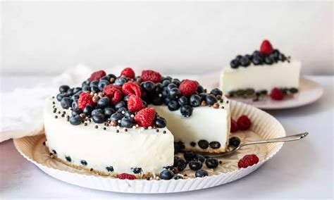 Anschnitt einer klassischen Quarktorte mit frischen Beeren und Quarkfüllung
