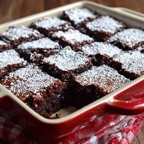 Auflaufform mit Brownies einfetten und Teig glattstreichen