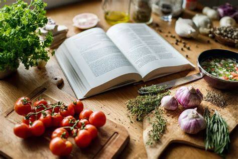 Autorin bei der Zubereitung der Torte, Rezeptbuch und Zutaten im Blick