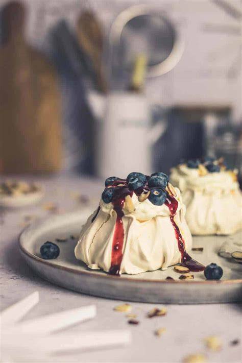 Baiser mit Sahne und frischen Beeren, garniert mit Minze