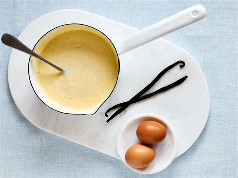 Bild: Vegane Vanillesoße in einem Glas, daneben Vanilleschote