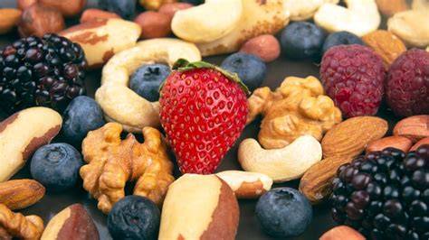 Dekorideen: Farbpuder in der Form, Nüsse und Beeren auf Tafeln, goldene Akzente