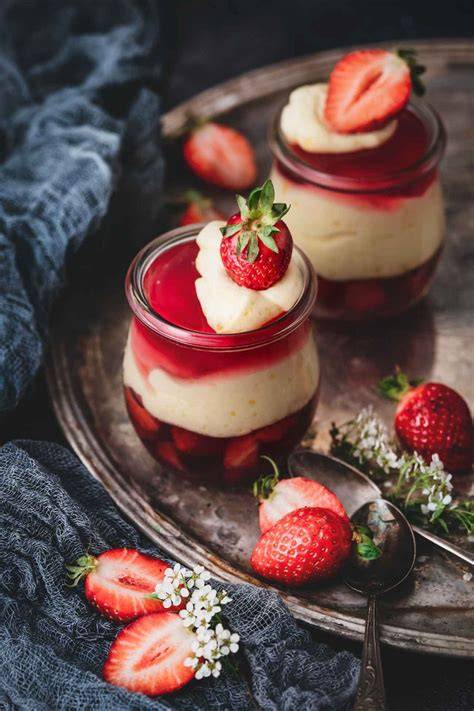 Dekorierte Gläser mit Götterspeise, Vanillepudding und Mangostreifen
