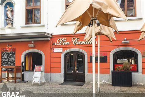 Don Camillo Pizzeria Innenraum mit Steinofen und Pasta-Gericht