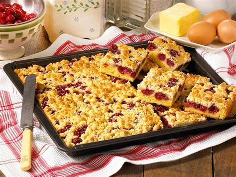 Ein Blech Kirsch-Pudding-Streuselkuchen frisch aus dem Ofen