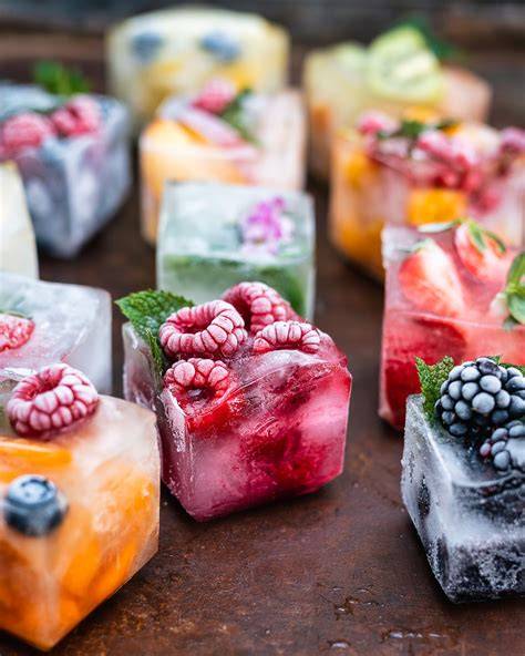 Eiswürfel mit Früchten und Blüten auf einer Torte