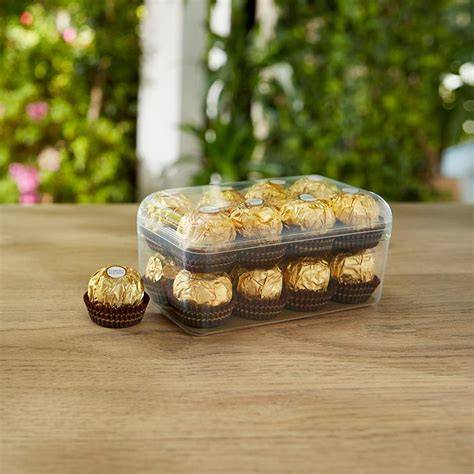 Elegante Ferrero Rocher Verpackung mit dem goldenen Logo auf dunklem Untergrund