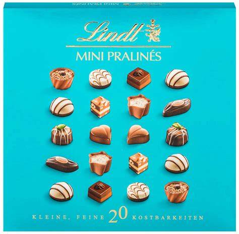 Elegante Flatlay-Aufnahme einer geöffneten Lindt Mini Pralinés Schachtel mit sortenreinen Pralinen