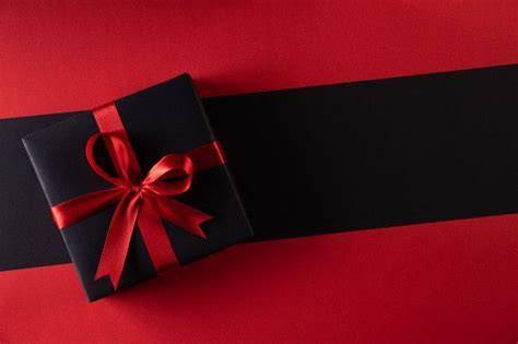 Elegante schwarze Geschenkbox mit rotem Papierkrissel