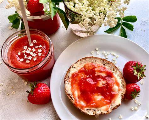 Erdbeermarmelade im Glas mit Holunderblüten