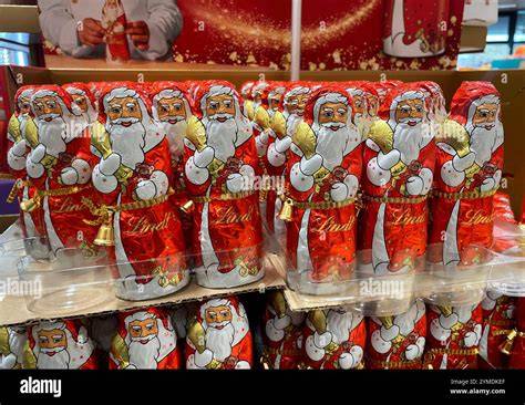 Familie genießt Lindt Weihnachtsmänner zur Adventszeit im festlich geschmückten Wohnzimmer