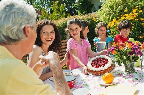 Familie isst selbst gebackenen Kuchen am Tisch