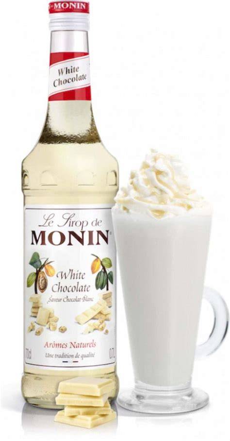 Flasche Monin Weiße Schokolade Sirup neben Kaffee, Desserts und Cocktails