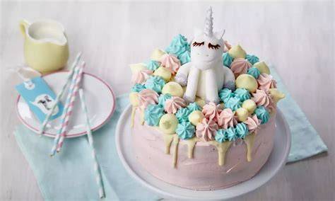 Foto einer zweistöckigen Einhorn-Torte mit goldener Hornspitze