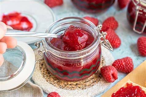 Frisch eingekochte Himbeermarmelade in Schraubgläsern