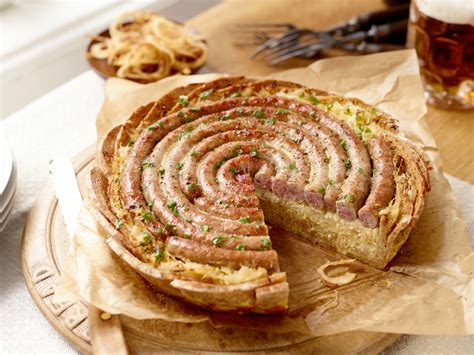 Frisch gebackene Bratwurst Torte mit Kräutern garniert