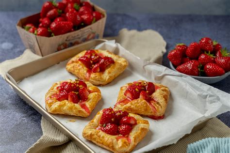 Frischer Blätterteig mit Erdbeeren auf Holzbrett