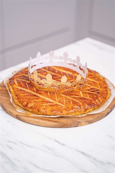 Galette des Rois auf einem Holzbrett mit Papierkrone