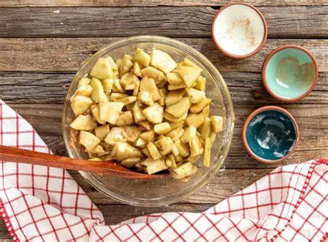 Geschnittene Äpfel in Schüssel mit Zimt und Zucker