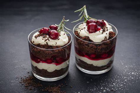 Gläser mit Kirsch-Dessert und Biskuitstücken