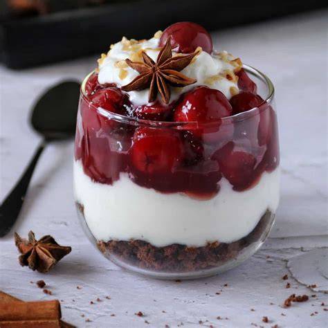 Gläser mit Schokoladen-Frischkäse-Dessert, Schokoladenraspel und Kirschen