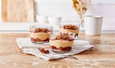 Gläser mit geschichteter Kinderschokoladen-Creme und Dekoration