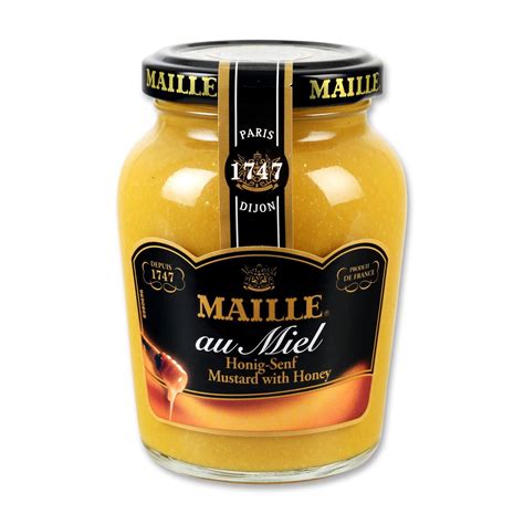 Glas Maille Senf mit Honig auf rustikalem Holztisch