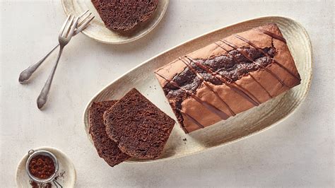 Hausgemachter, saftiger Kaffeekuchen auf einem rustikalen Holztisch mit Kaffee