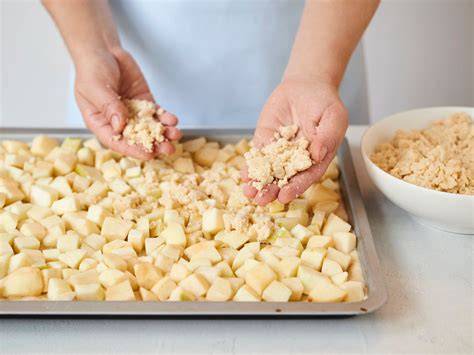 Hefeteig auf dem Blech, Streusel werden verteilt
