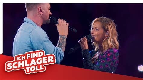 Helene Fischer und Ben Zucker auf einer Stadionbühne vor großem Publikum