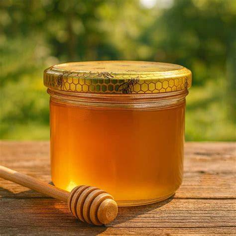 Honigglas mit Sedimenten und Bienenwaben