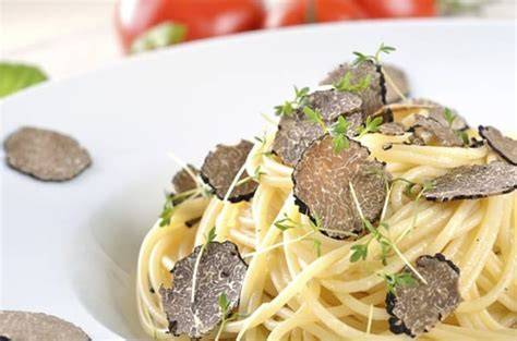 Küchenszene: Frische Trüffel über Pasta gehobelt