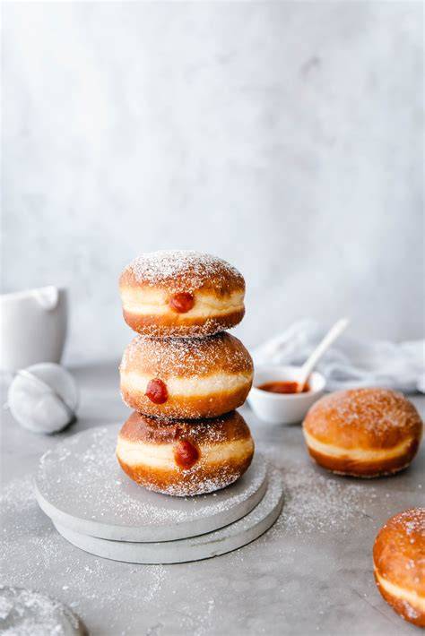 Krapfen in Zucker gewälzt auf einer Servierplatte, mit Marmeladenfüllung
