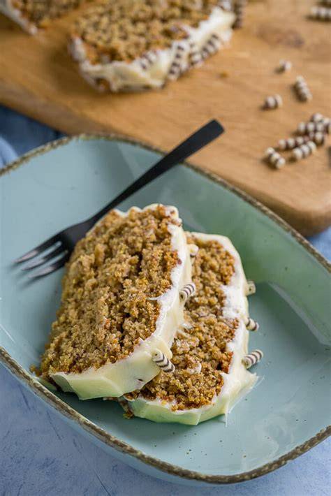 Kuchen mit Frischkäse-Frosting und gehackten Nüssen