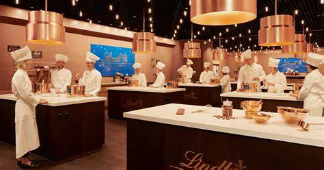 Lindt Maîtres Chocolatiers bei der Herstellung von Schokoladenpralinen