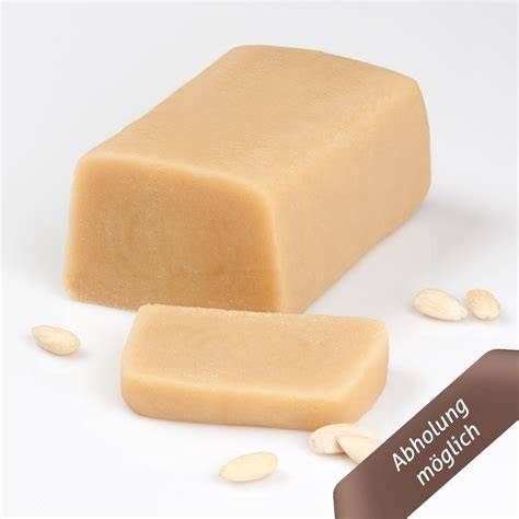 Marzipan-Rohmasse und Mandeln in Nahaufnahme