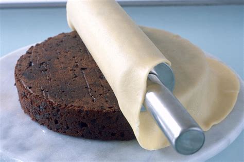 Marzipandecke ausrollen und auf Kuchen legen