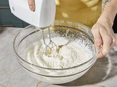 Mascarpone-Sahne-Creme in einer Rührschüssel samt Rührstäben