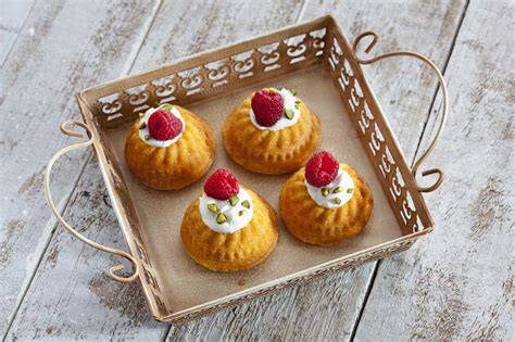 Mini-Vanillecupcakes mit Himbeeren auf einem Tablett