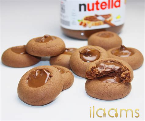 Nutella-Cookies auf Backpapier, Zutaten im Glas
