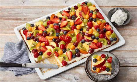 Obstschnitten auf dem Blech mit Puddingcreme und Beeren
