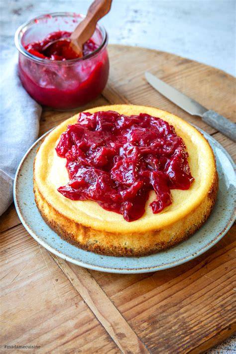 Omas Käsekuchen mit Pflaumen auf einem Kuchenteller dekoriert