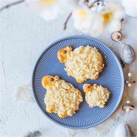 Osterschäfchen aus Hefeteig mit Vanillepudding und Streuseln auf rustikalem Blech