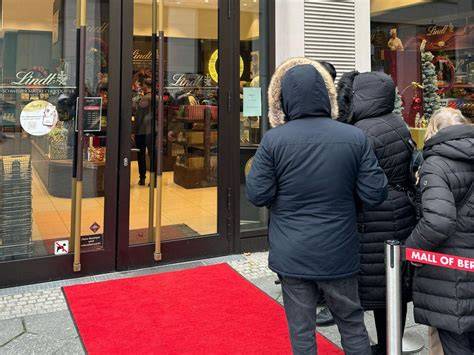 Personen in Schlange vor Lindt-Store Düsseldorf Berlin