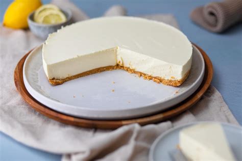 Philadelphia-Torte mit Minze und Zitronenscheiben garniert, Serviervorschlag auf sommerlichem Tisch
