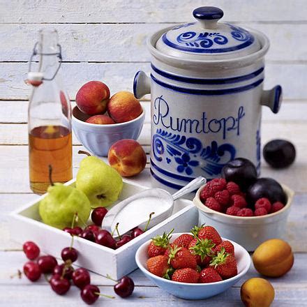 Rumtopf im Steingutgefäß mit Früchten und Zucker