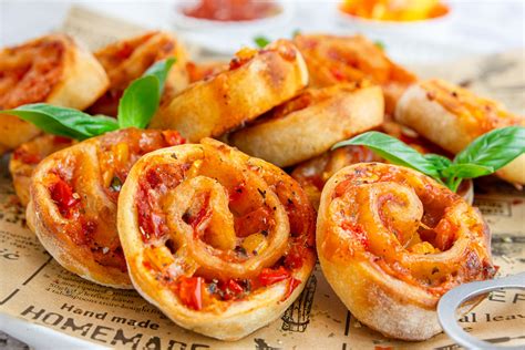 Süße Minipizzen und Pizzaschnecken auf einem Buffet